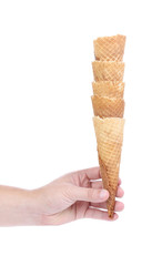 Hand holds stake of wafer cup for ice-cream.
