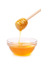 Honey dripping from a wooden dipper