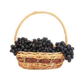Fototapeta na wymiar Black ripe grapes in basket