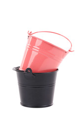Black and pink metal buckets.