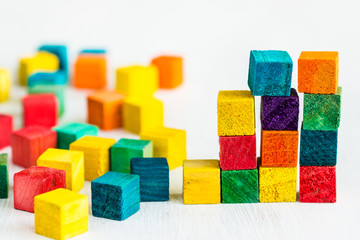 Colorful wooden building blocks on white background.
