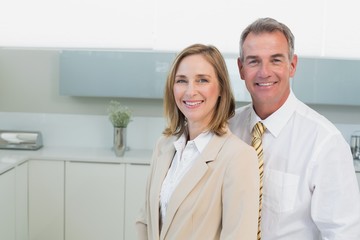 Portrait of a business couple standing in kitchen
