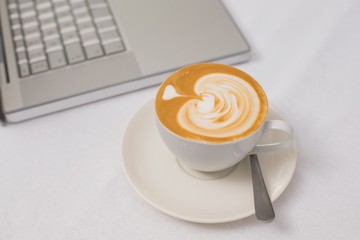 Coffee and laptop on table