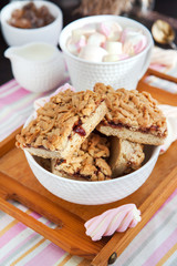 Jam filled bar cookies and cup of hot cocoa