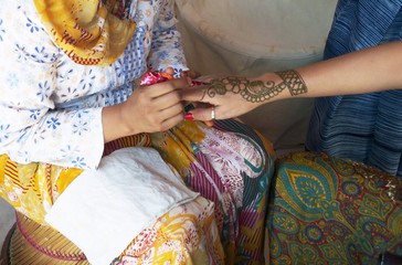 Hand being decorated with henna India
