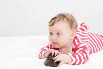 infant touching smart phone, early learning © nadezhda1906