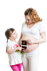 Pregnant woman and her kid daughter reviewing baby ultrasound sc