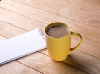 coffee cup with notebooks.