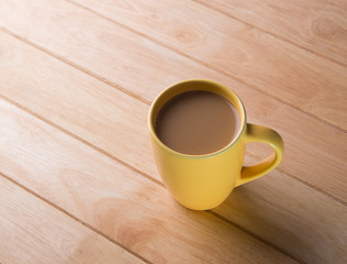 Coffee cup placed on a wooden floor.