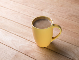 Coffee cup placed on a wooden floor.