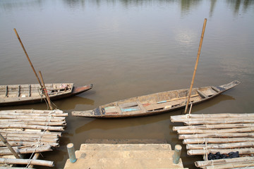 Old wooden row boat and raft on water