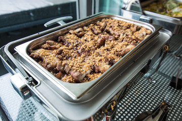 Roasted pork in a metal food block