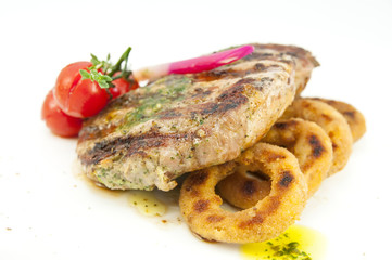 Grilled steak with sauce and greens on white background
