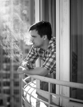Monochrome portrait of depressed man smoking