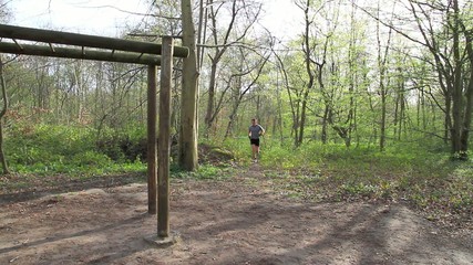 Young man working out in the forrest 