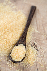 brown cane sugar in a wooden spoon