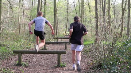 Father and Son running in the forest 