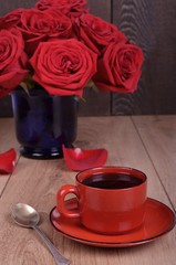Bouquet of withered roses and coffee cup