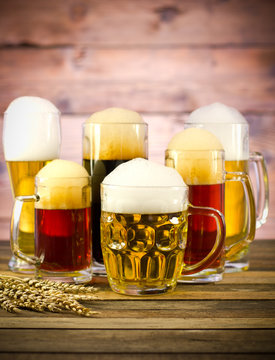 Variety of beer glasses on a wooden table