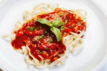 Pasta fettuccine with tomato sauce and basil