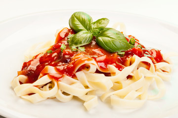 Pasta fettuccine with tomato sauce and basil