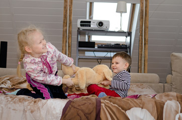 Cute brother and sister having a tug of war