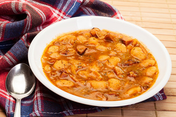 Beans with tomato sauce, bacon and sausage