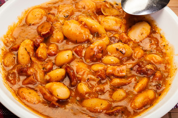 Beans with tomato sauce, bacon and sausage