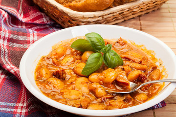 Beans with tomato sauce, bacon and sausage