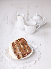 A piece of pecan cake with buttercream icing