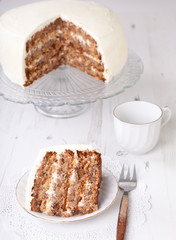 A piece of pecan cake with buttercream icing
