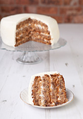 A piece of pecan cake with buttercream icing