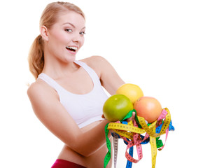 Fototapeta na wymiar Fit woman with measure tapes fruits. Time for diet slimming.