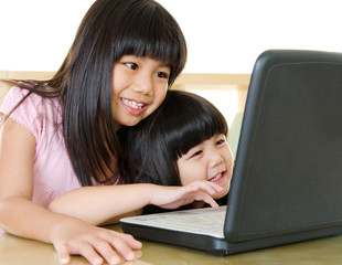 Asian kids using laptop
