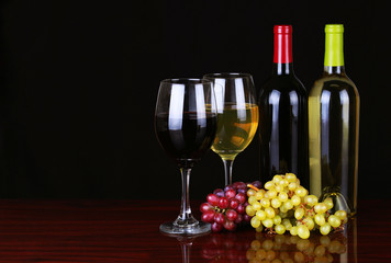 Wine Bottles and Glasses of Wine over black background. © Guzel Studio