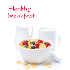 cornflakes with fresh berries in a bowl and milk, isolated