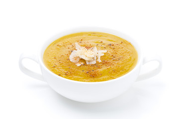 cream soup of yellow lentils in a bowl, isolated