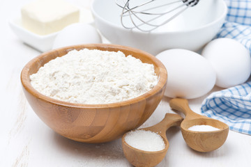 Fototapeta na wymiar flour, salt, sugar and eggs for baking pancakes on wooden table