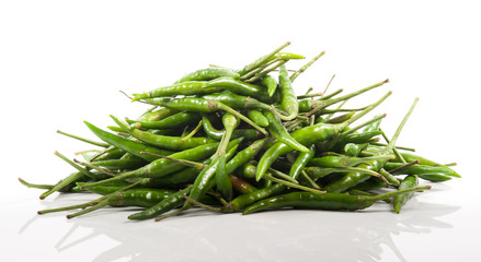 bunch of fresh green chili peppers on a white background