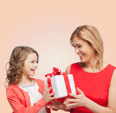 Smiling Mother And Daughter With Gift Box