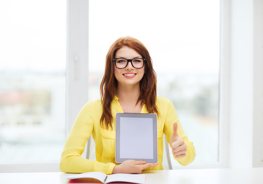 smiling student girl in eyelgasses with tablet pc