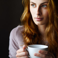 Beautiful and relaxed girl drinking tea