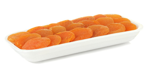 delicious dried apricots in packaging isolated on white