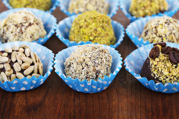 Set of chocolate candies, on wooden background