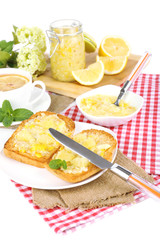Delicious toasts with lemon jam on plate on table close-up