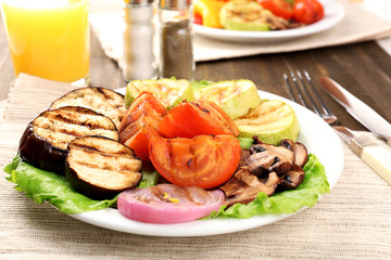 Delicious grilled vegetables on plate on table close-up