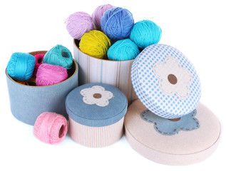 Decorative boxes with colorful skeins of thread isolated