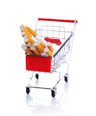 Cigarettes in shopping cart isolated on white