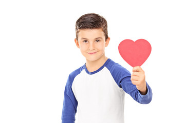 Young boy holding a red heart