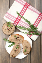 Fresh pate with bread on wooden table